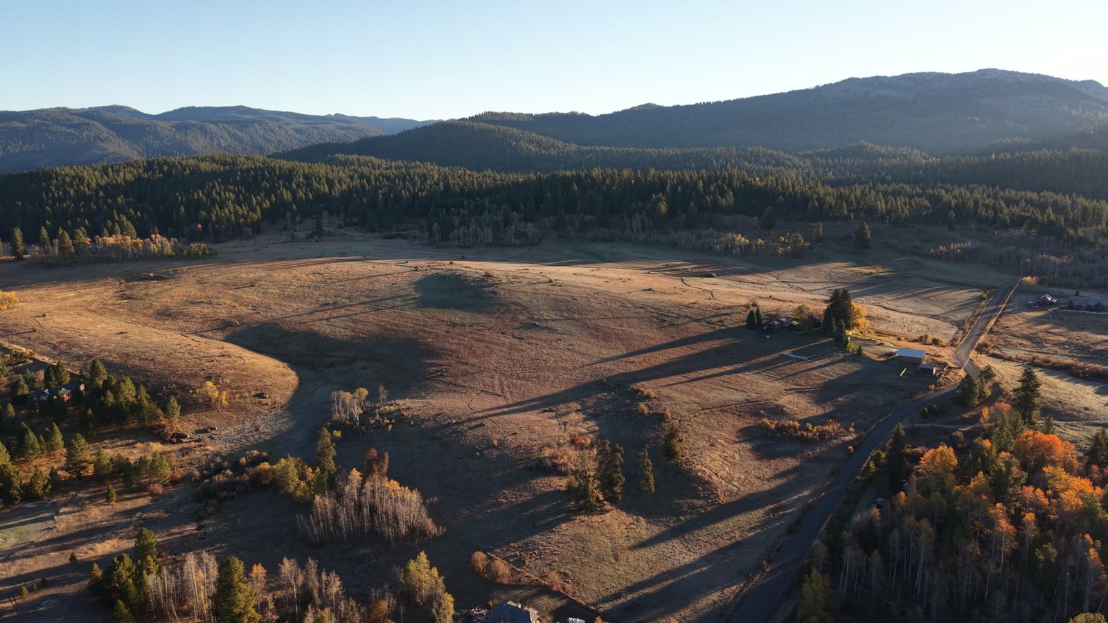 The open meadow at Shaw Ranch in autumn light with long morning shadows